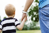 Parent walking with child through the park