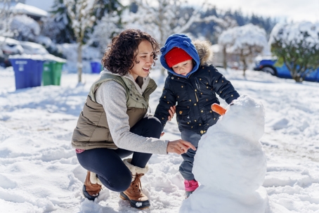 mother and son playing in the snow