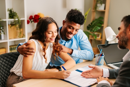 couple meeting with a lawyer signing documents