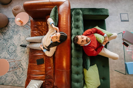 stressed couple sitting on different couches